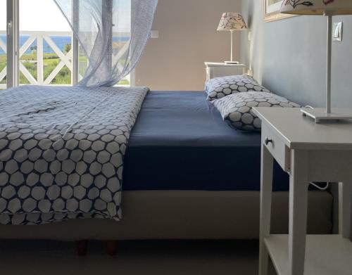 a bedroom with two beds with a window and a desk at Betty's Villas in Korakokhórion
