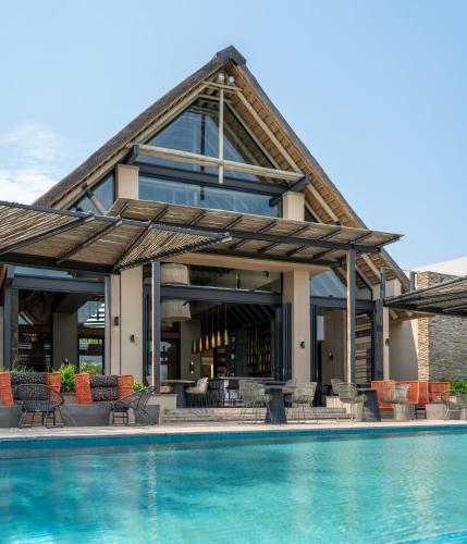 an image of a house with a swimming pool at Radisson Safari Hotel Hoedspruit in Hoedspruit