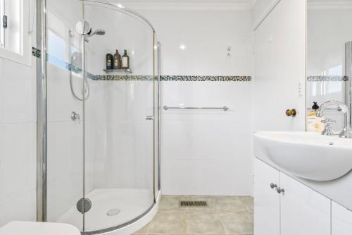 a bathroom with a shower and a sink at Hampton Vintage Soul with Pool in Melbourne