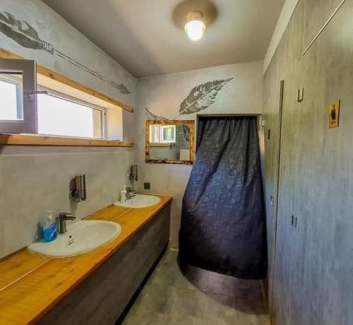 a bathroom with two sinks and a wooden counter at Apache Eco Camp, Terelj Nationalpark Mongolia in Bayan Bulagiin Hural