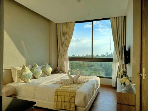 a hotel room with a bed with a large window at Phu Dahla Residences in Ao Nang Beach