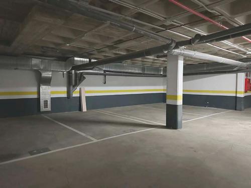 an empty parking garage with a large parking lot at Apartamentos Las Margas Sabiñánigo 3000 in Sabiñánigo