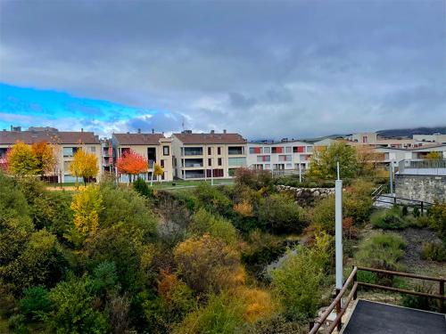 a view of a city with buildings and trees at Apartamentos Las Margas Sabiñánigo 3000 in Sabiñánigo