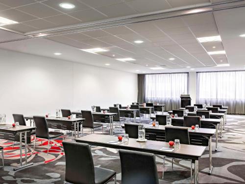 a large room with tables and chairs in it at Adelaide Rockford in Adelaide
