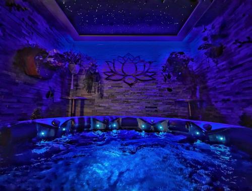 a hot tub in a room with purple lights at Hambrook House Canterbury - NEW luxury guest house with ESPA Spa complex in Canterbury