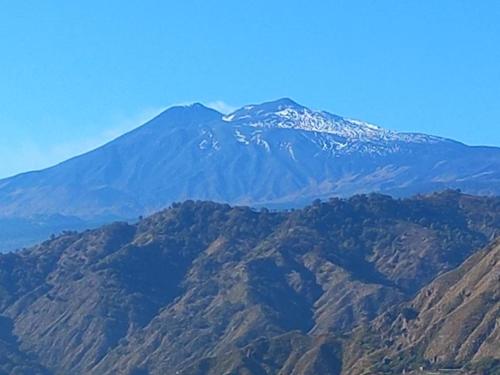 a mountain with snow on top of it at Antico Borgo - A due passi dalle Gole Alcantara in Motta Camastra