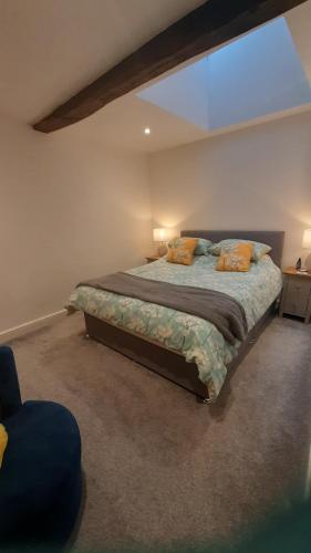 a bedroom with a large bed in a room at Joiners cottage in Penrith