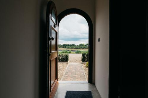 an archway leading to a door with a view at Maashuys in Lanaken