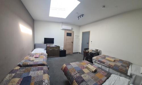 a room with two beds and a television in it at Es8bar in Łozina