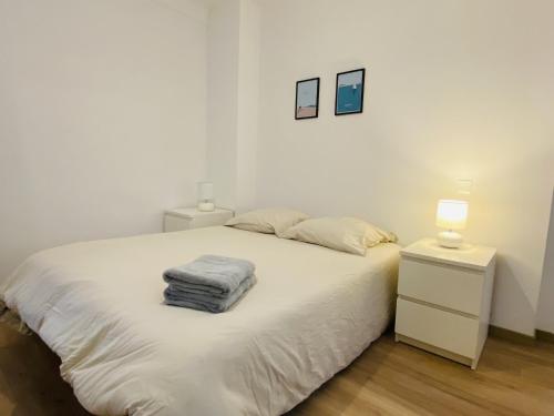 een slaapkamer met een wit bed en 2 nachtkastjes bij Le haut layoule in Rodez