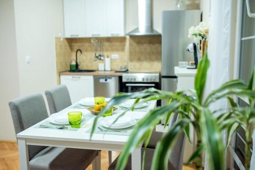 a kitchen with a table with two glasses on it at Apartman Centar in Požarevac