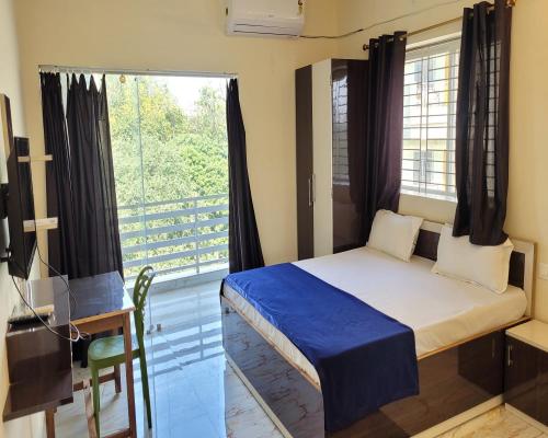 a bedroom with a bed and a large window at Hotel Soft Petal in Rānchī