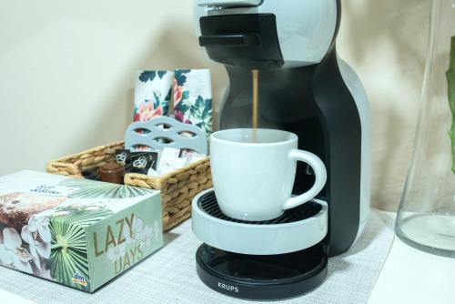 a coffee maker is making a cup of coffee at Apartman Centar in Požarevac