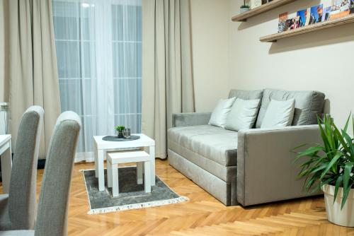 a living room with a couch and a table at Apartman Centar in Požarevac