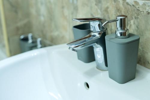 a bathroom sink with a faucet on top of it at Apartman Centar in Požarevac