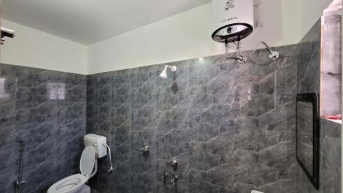 a bathroom with a shower and a toilet at Hotel Soft Petal in Rānchī