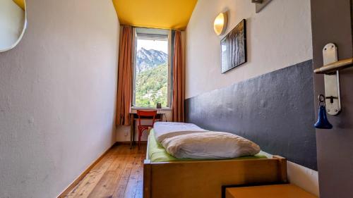 a bedroom with a bed with a window and a table at Villa Edera Exclusive Rental in Auressio