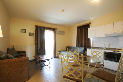 a kitchen and a living room with a table and a couch at Diamond Palace in Gythio