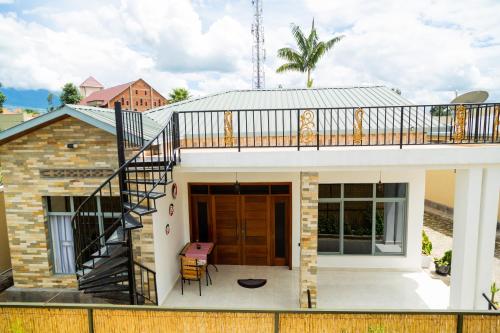 a house with a balcony and a staircase at Mgahinga residence in Gasanze