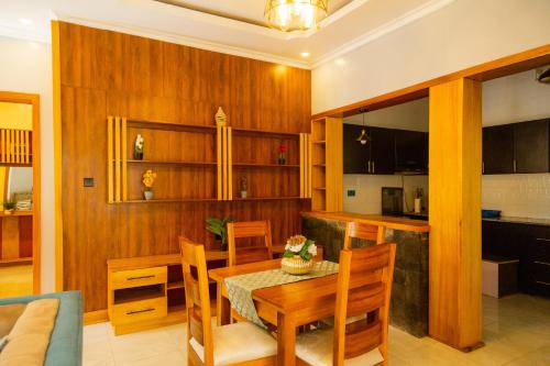 a kitchen and dining room with a table and chairs at Mgahinga residence in Gasanze