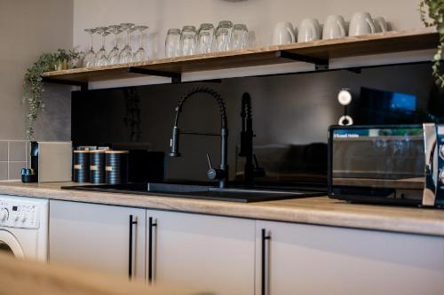 a kitchen with a sink and a stove top oven at Host & Stay - Ropewalks Quarters in Liverpool