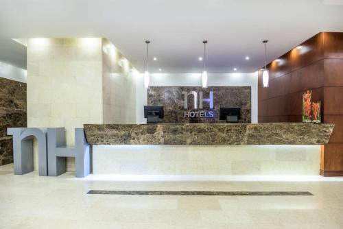 a lobby of a hotel with a reception desk at NH Bogota Pavillon Royal in Bogotá