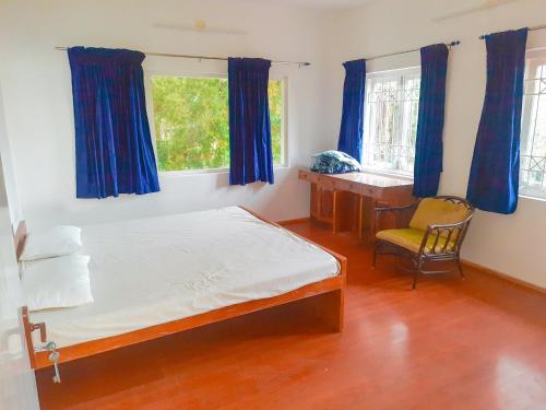 - une chambre avec un lit, un bureau et une fenêtre dans l'établissement HappyHuts at Green valley view, à Kodaikānāl