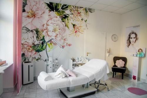 a hospital room with a bed and flowers on the wall at Hotel Villa Elsa in Bad Kissingen