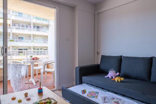 a living room with a blue couch and a table at Apartamentos California in Salou