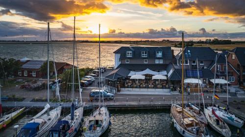a group of boats docked at a marina at sunset at Meerblick Lemkenhafen in Fehmarn