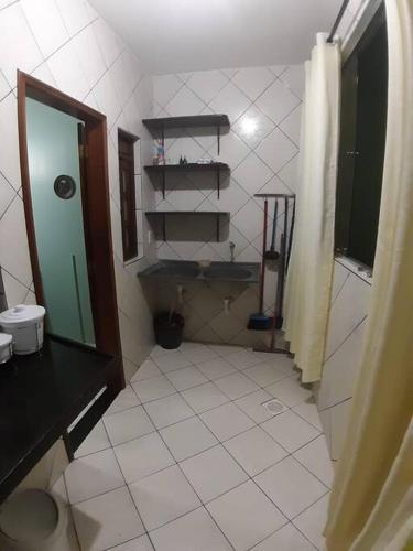 a bathroom with a sink and a mirror at Apartamento inteiro( 1° andar) - Guarabira/PB in Guarabira
