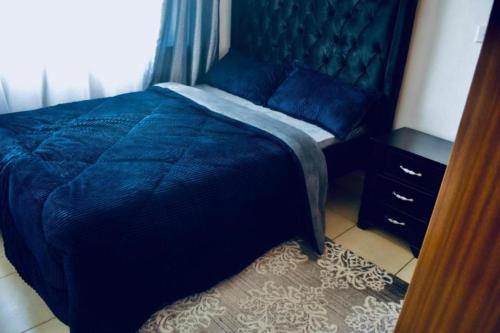 Katil atau katil-katil dalam bilik di Honey Dew Greatwall Apartments