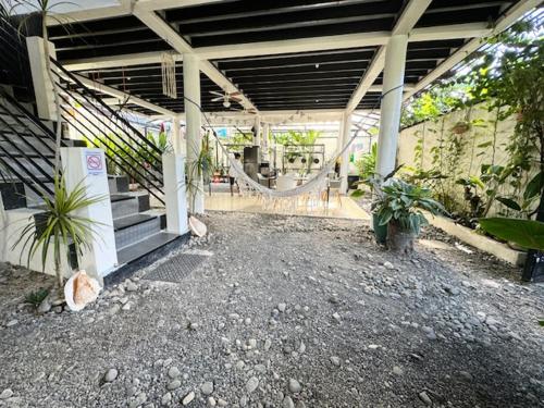 a building with stairs and potted plants in it at Mahajab Homestay SIARGAO in General Luna