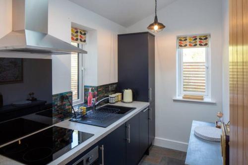 a kitchen with a sink and a counter top at The Tullet, boutique hideaway in Somerset in Banwell