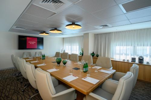 a conference room with a long table and chairs at Leonardo Plaza Haifa in Haifa