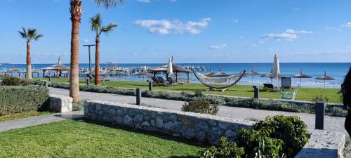 a park with a beach with umbrellas and the ocean at Four seasons sea holiday in Iskele