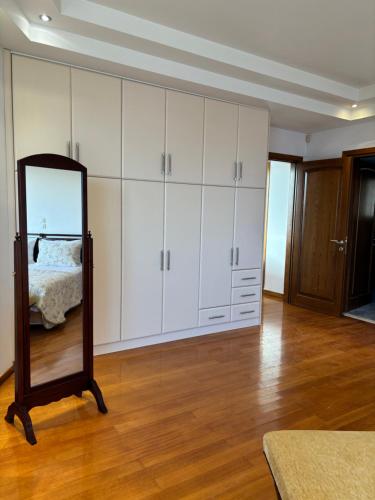 a room with white cabinets and a mirror at Liberty - Classic luxury sea view villa with private pool, Panoramic views to Kommeno & Corfu old Town in Kommeno