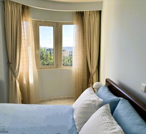 a bedroom with a bed and a window at Liberty - Classic luxury sea view villa with private pool, Panoramic views to Kommeno & Corfu old Town in Kommeno