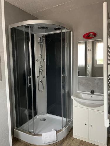 a bathroom with a shower and a sink at Au Petit Bonheur in La Tranche-sur-Mer