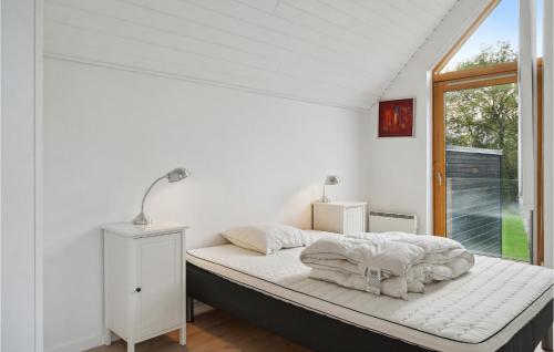 a white bedroom with a bed with a window at Gorgeous Home In Stubbekbing With Kitchen in Stubbekøbing