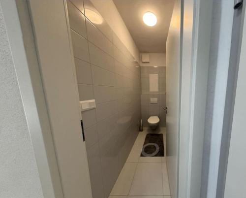 a small bathroom with a toilet in a room at Moderné ubytovanie v Senici in Senica
