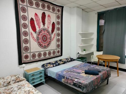 a bedroom with a bed and a rug on the wall at KALIFORNIA CENTRAL in Alicante