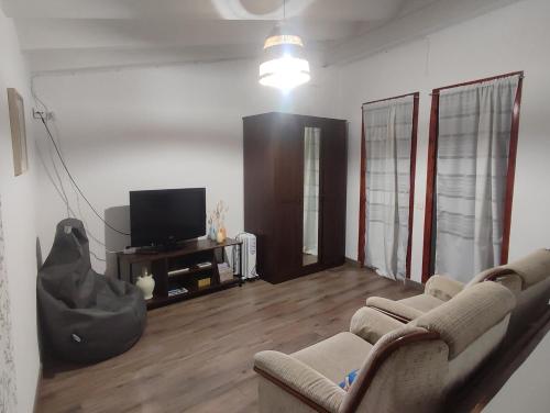 a living room with a couch and a tv at CASA DALMA in Ballestar