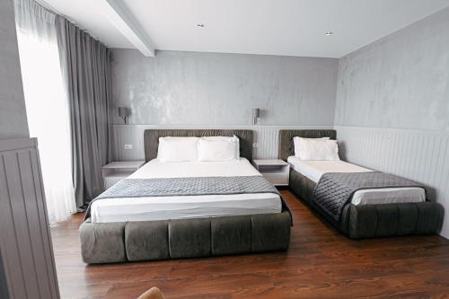 a bedroom with two beds in a room at Royal G Max in Golem