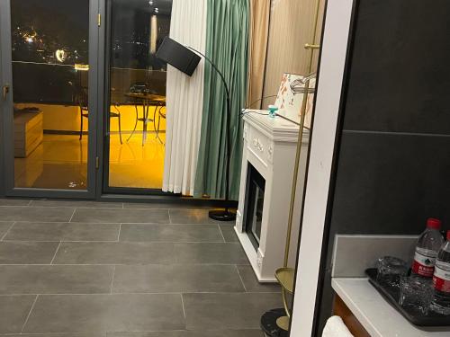 a room with a fireplace and a living room at Phoenix Best River View B&B in Fenghuang