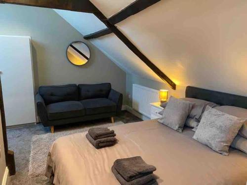 a bedroom with a large bed and a couch at Church View in York