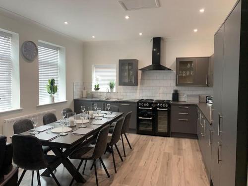 a kitchen with a table with wine glasses on it at Church View in York