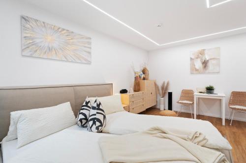 two beds in a bedroom with white walls at ANYTIME - Apartments in Langenargen in Langenargen