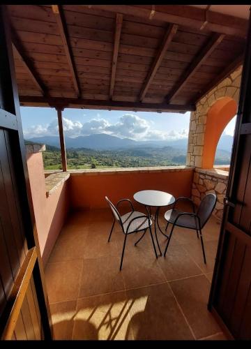 a balcony with a table and two chairs and a view at Vytina Mountain View Hotel in Vytina