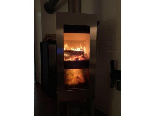 a fireplace with a fire in it in a room at Ferienhaus-Christel in Langeoog